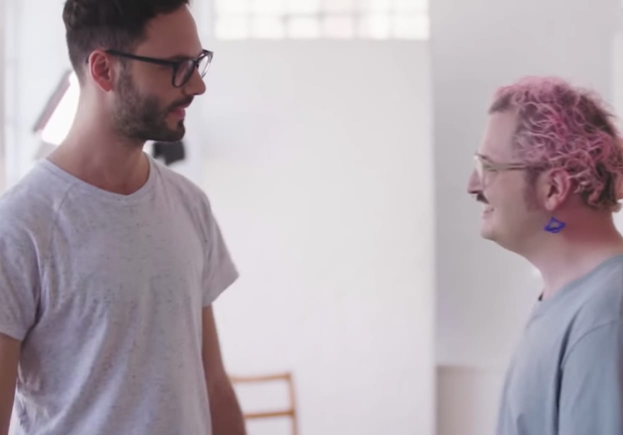 Two men in discussion in an office environment.