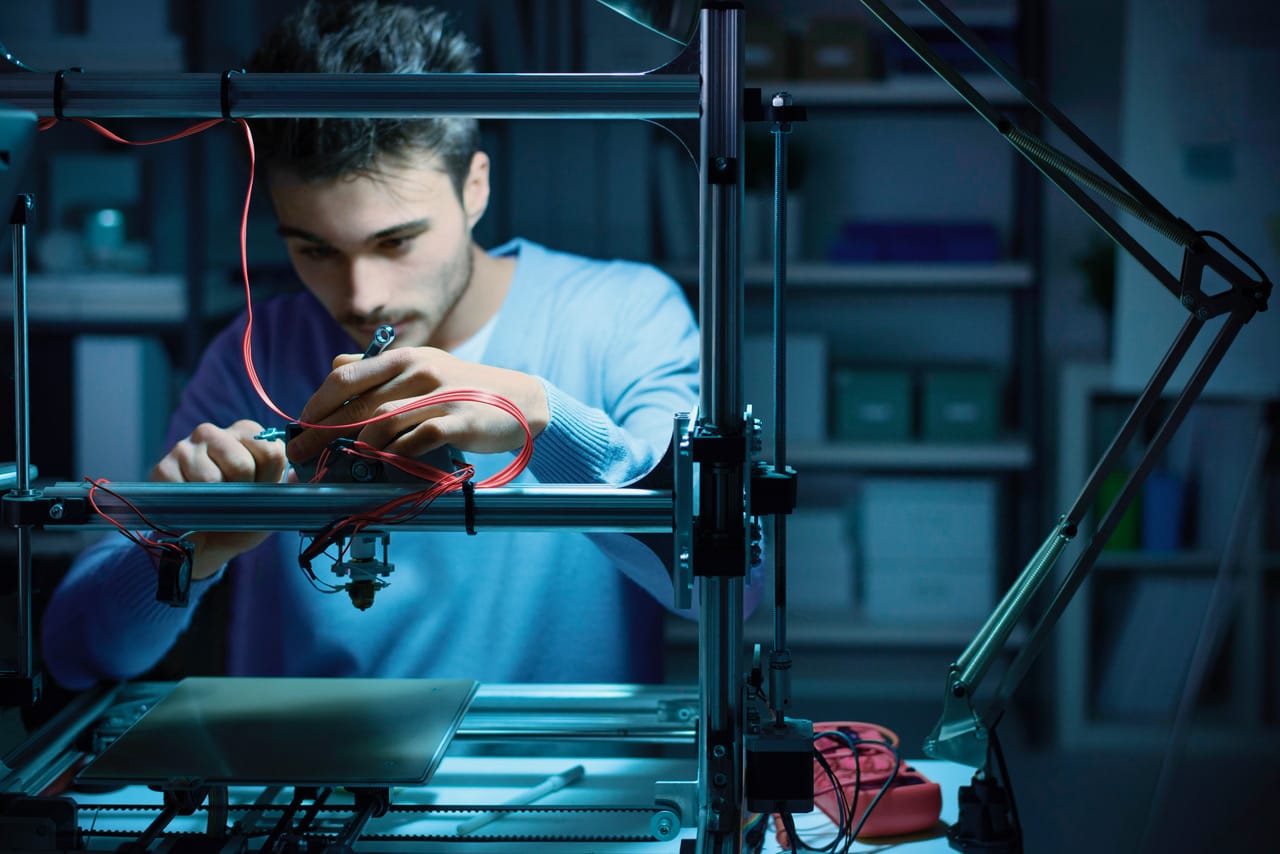 Man repairs a circuit board.