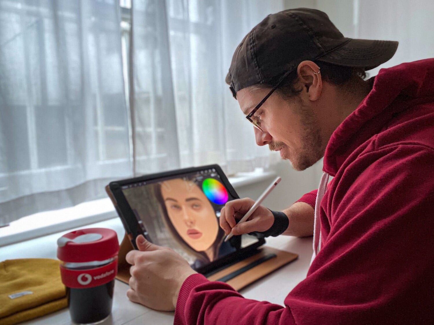 Artist draws a portrait on a digital screen.