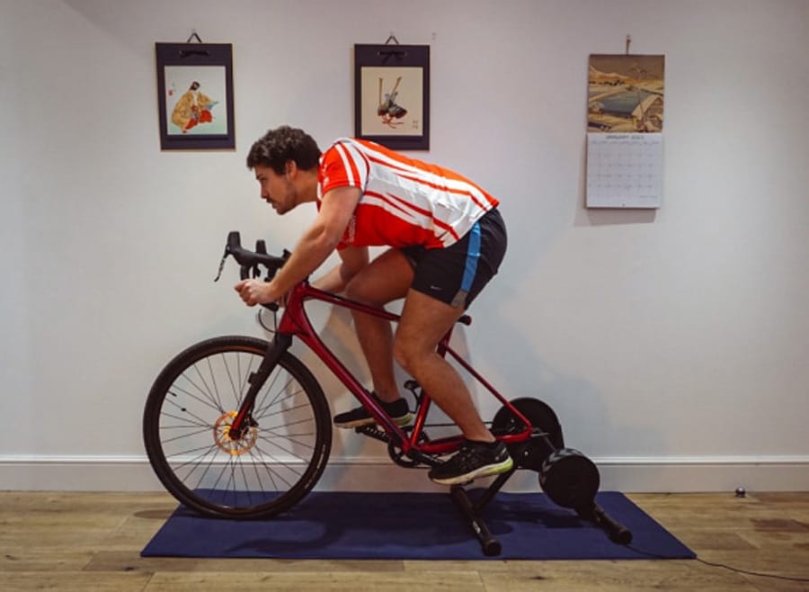 Man on exercise bike indoors.